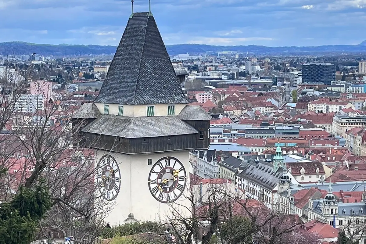 View of the Graz Clock Tower Uhrturm and the red tiled roofs of Graz from the Chinese Pavillion on the Schlossberg